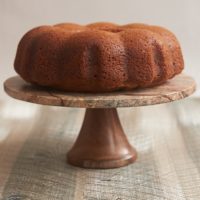 Amaretto Cake on a wood and marble cake stand
