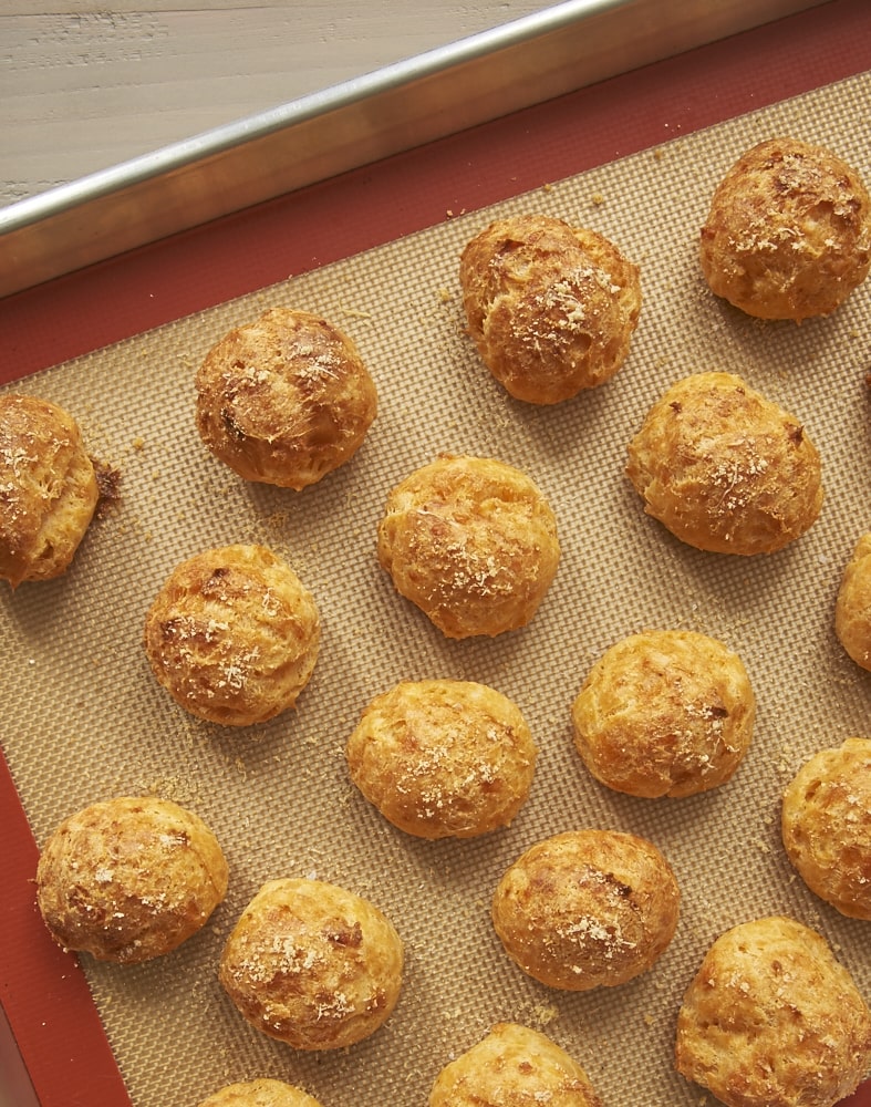 Gougeres on a baking sheet lined with a silicone liner