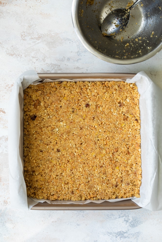 crust for Limoncello Cheesecake Squares pressed into a parchment-lined pan