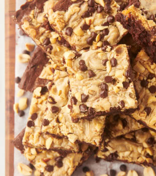 Overhead view of peanut butter swirl brownies stacked on board