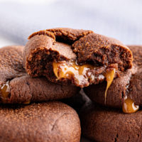 Stack of chocolate caramel cookies with caramel seeping out