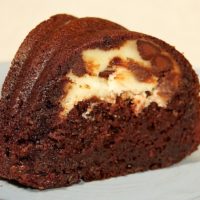 A slice of marbled chocolate bundt cake on a plate