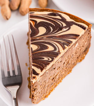 Top-down view of chocolate peanut butter cheesecake slice on plate with fork