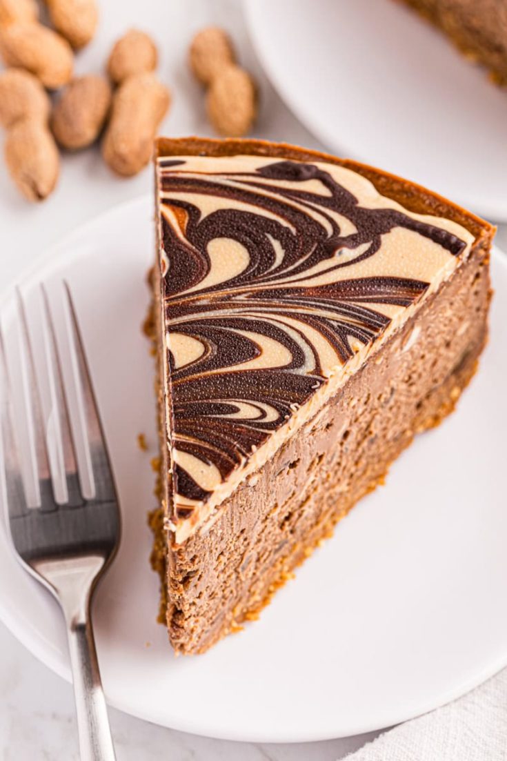 Top-down view of chocolate peanut butter cheesecake slice on plate with fork