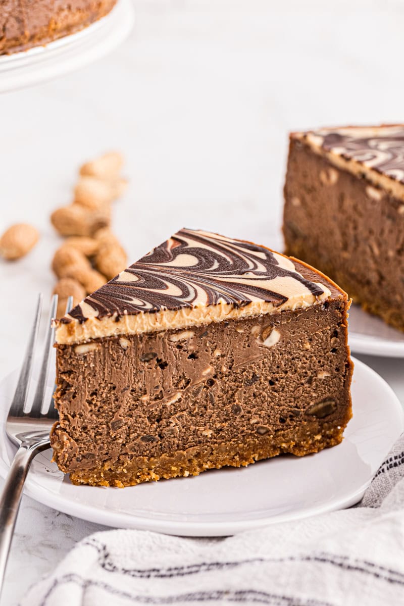 Side view of chocolate peanut butter cheesecake, showing height and creaminess
