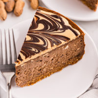 Slice of chocolate peanut butter cheesecake on white plate