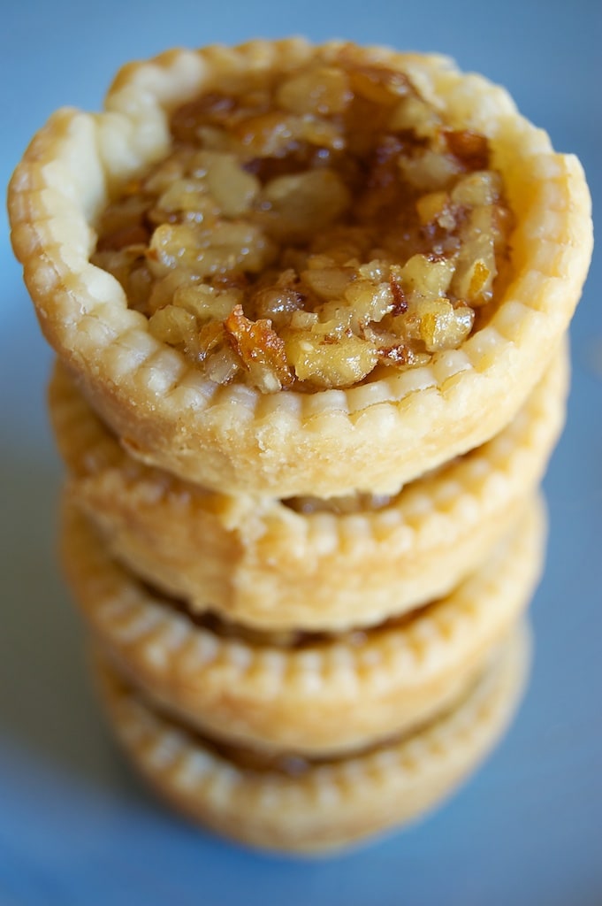 stack of Mini Pecan Pies on a blue plate