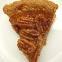 A slice of classic pecan pie on a plate.