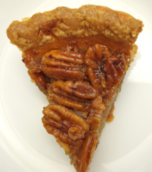 A slice of classic pecan pie on a plate.