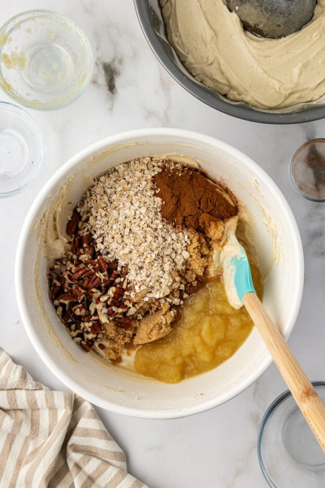 Adding cinnamon, oats, and nuts to batter