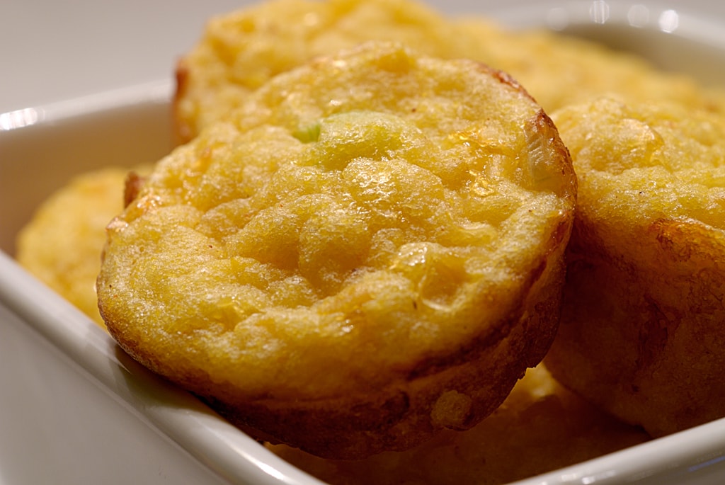 Bite sized corn bread on a serving plate.