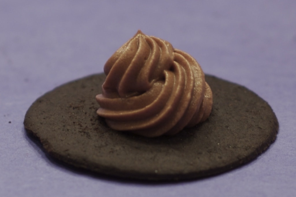 A decadent swirl of silky gianduja mousse on a cookie.