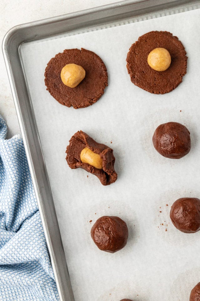 Tucking filling into chocolate dough for peanut butter-filled chocolate cookies