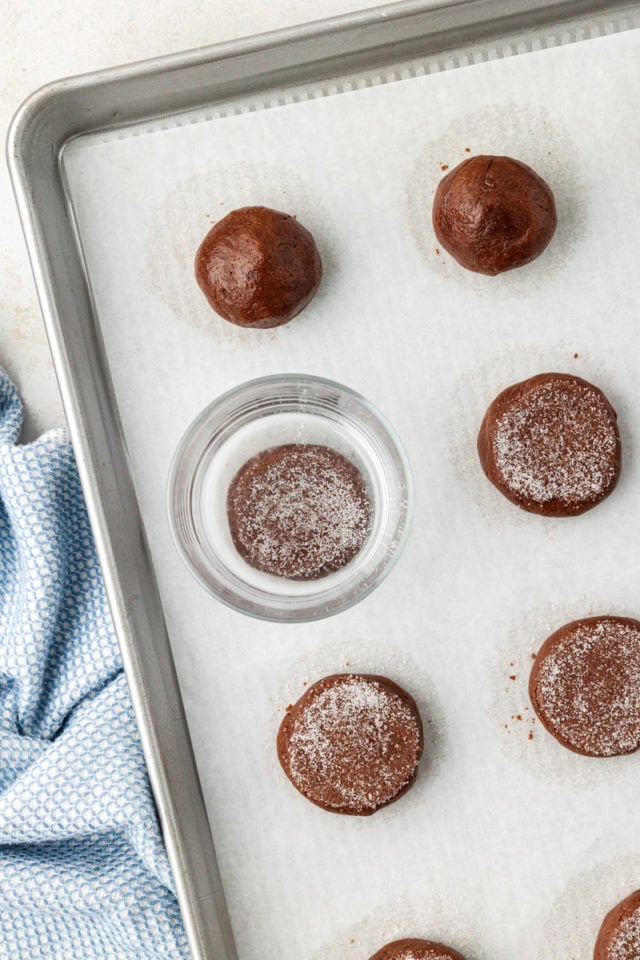 Flattening peanut butter-filled chocolate cookies with glass