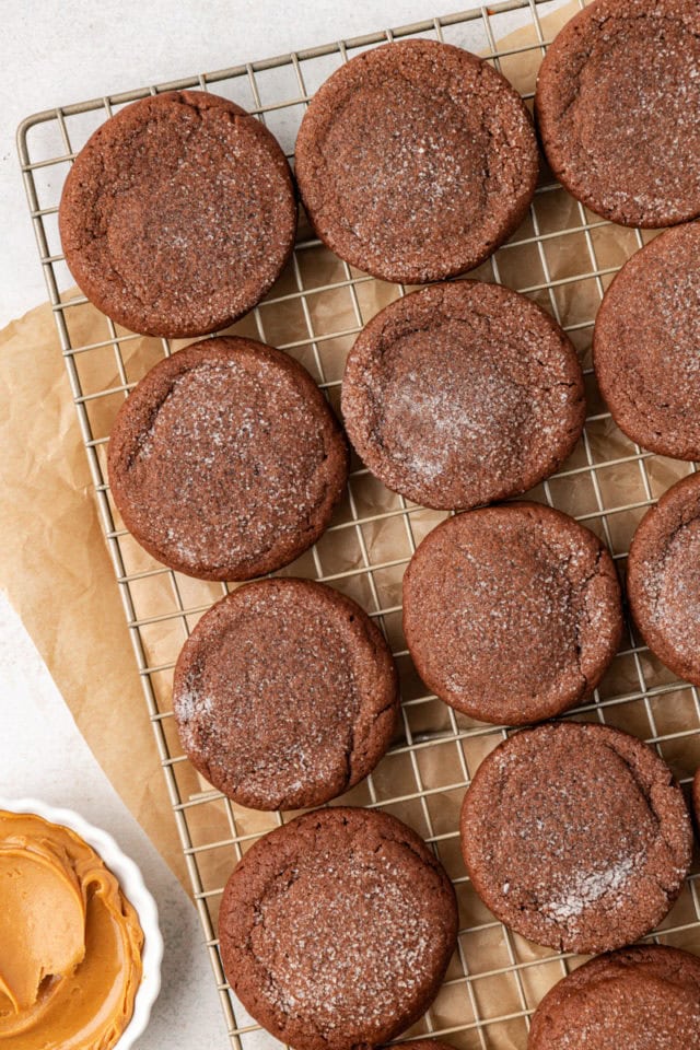 Overhead view of peanut butter-filled chocolate cookies on wire rack