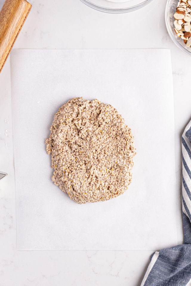 Overhead view of zimtsterne dough on parchment paper