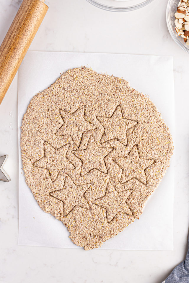 Overhead view of zimtsterne dough cut into stars