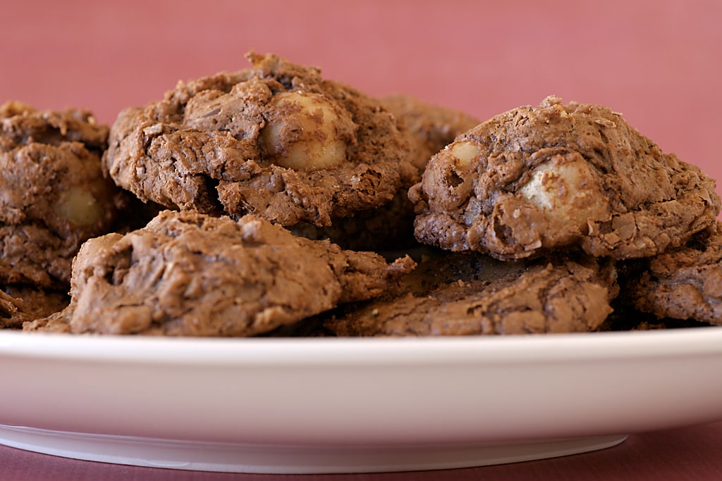 A selection of chocolate macadamia nut clusters on a plate.