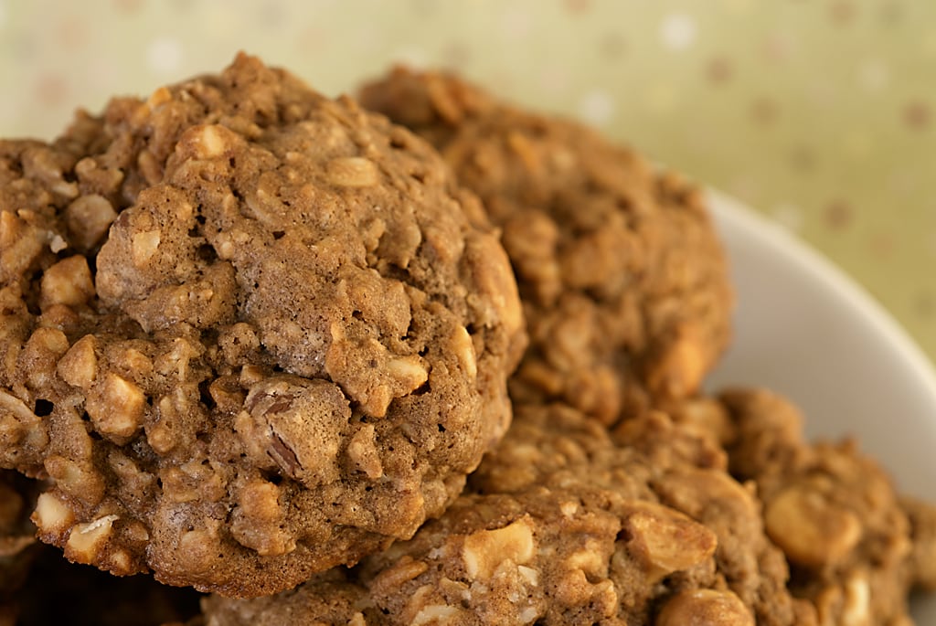 A close-up of a monster cookie showing the chocolate chips and chopped cashews baked into the batter.