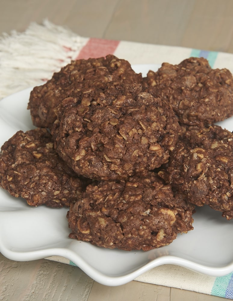 A pile of fudgy monster cookies on a plate.