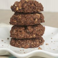 A stack of 4 cashew-stuffed monster cookies on a plate.