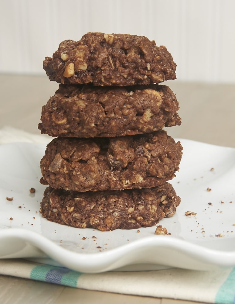 A stack of 4 cashew-stuffed monster cookies on a plate.