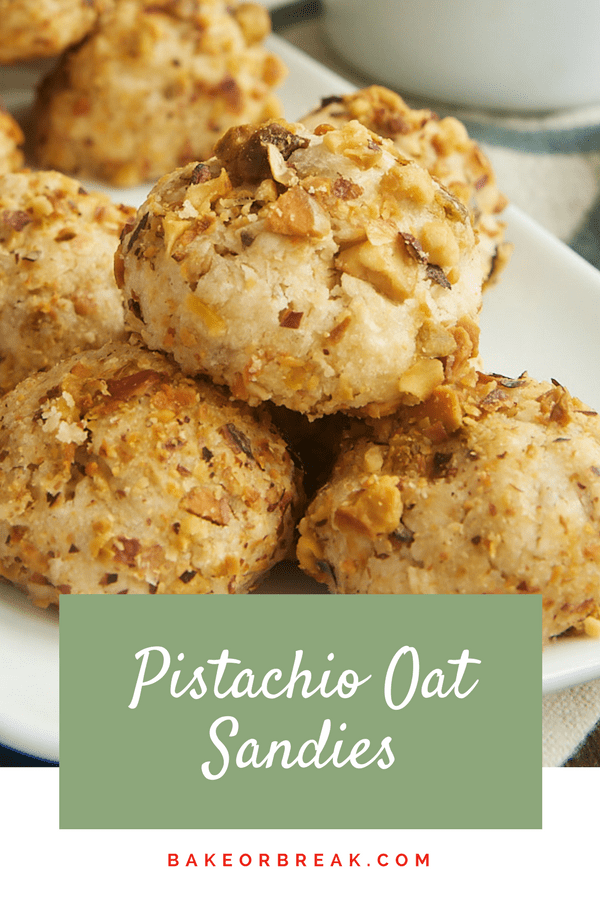 Pistachio oat sandies piled up on a plate.