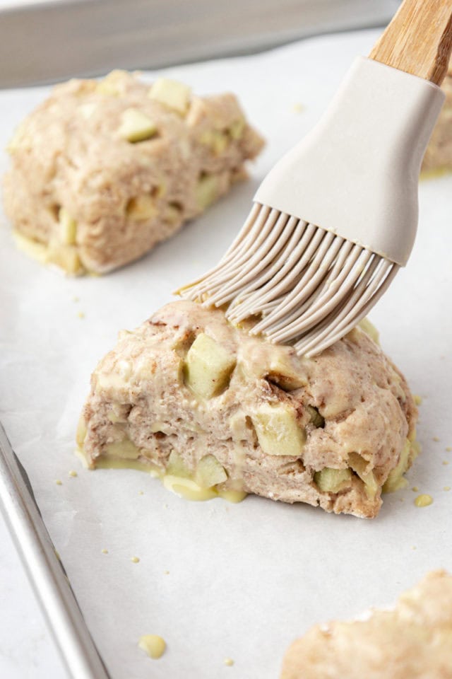 Brushing egg wash onto apple cinnamon scones