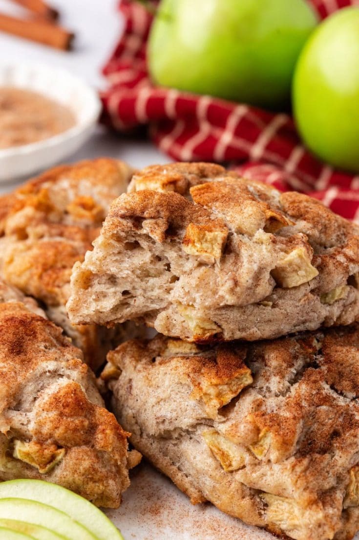 Flaky apple cinnamon scones stacked on countertop