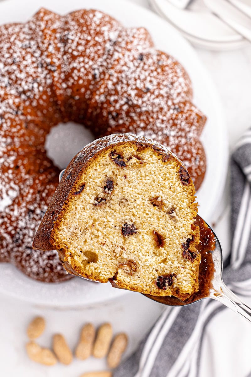 Lifting slice of peanut butter pound cake from cake stand