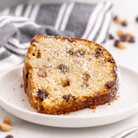 Slice of peanut butter pound cake on plate, dusted with powdered sugar