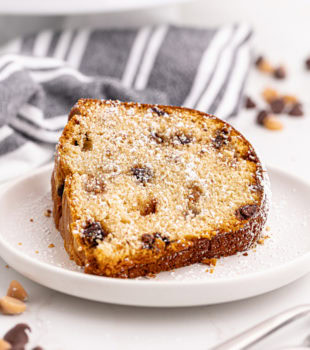 Slice of peanut butter pound cake on plate, dusted with powdered sugar