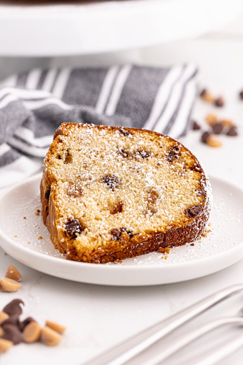 Slice of peanut butter pound cake on plate, dusted with powdered sugar