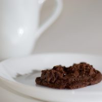 A chocolate cookie on a white plate