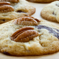 Triple Chocolate Pecan Cookies on parchment paper