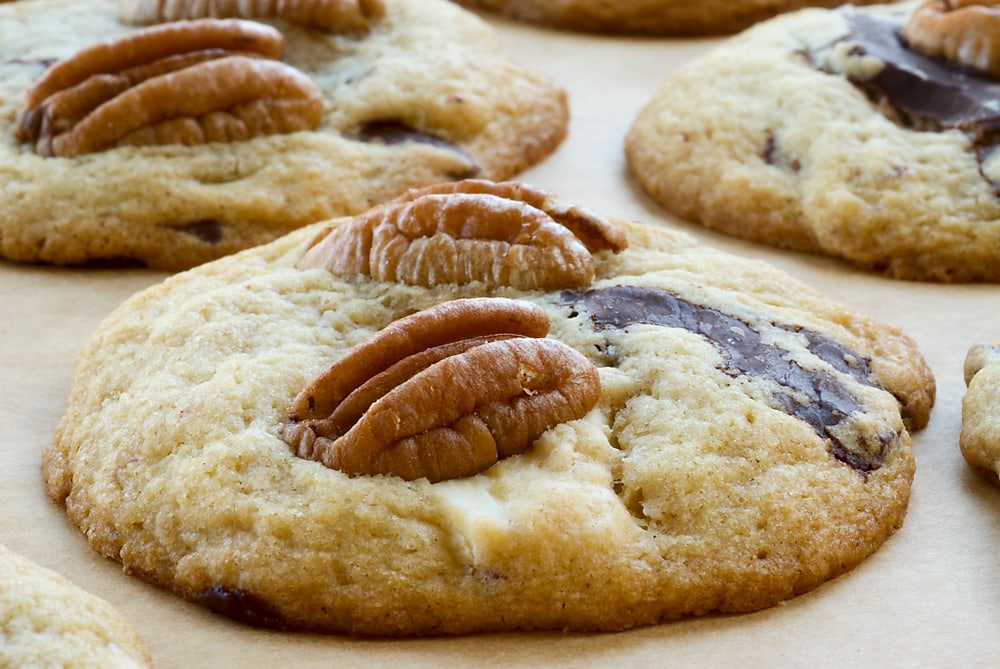 Triple Chocolate Pecan Cookies on parchment paper