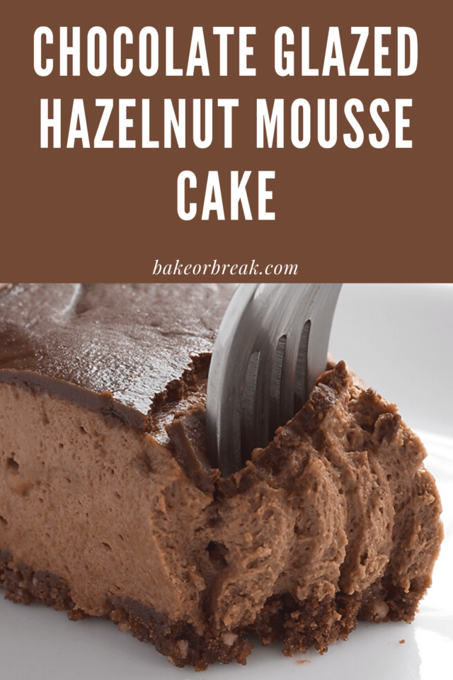 Chocolate-Glazed Hazelnut Mousse Cake with ganache on a plate.