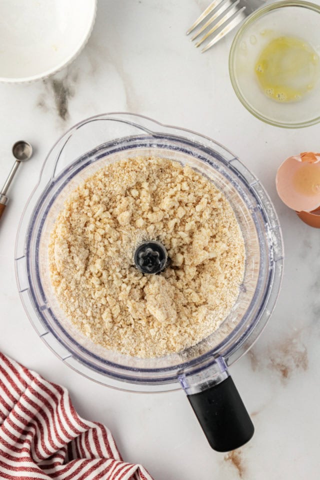 Overhead view of crust mixture in food processor bowl