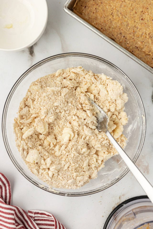 Overhead view of crumb topping in mixing bowl with fork