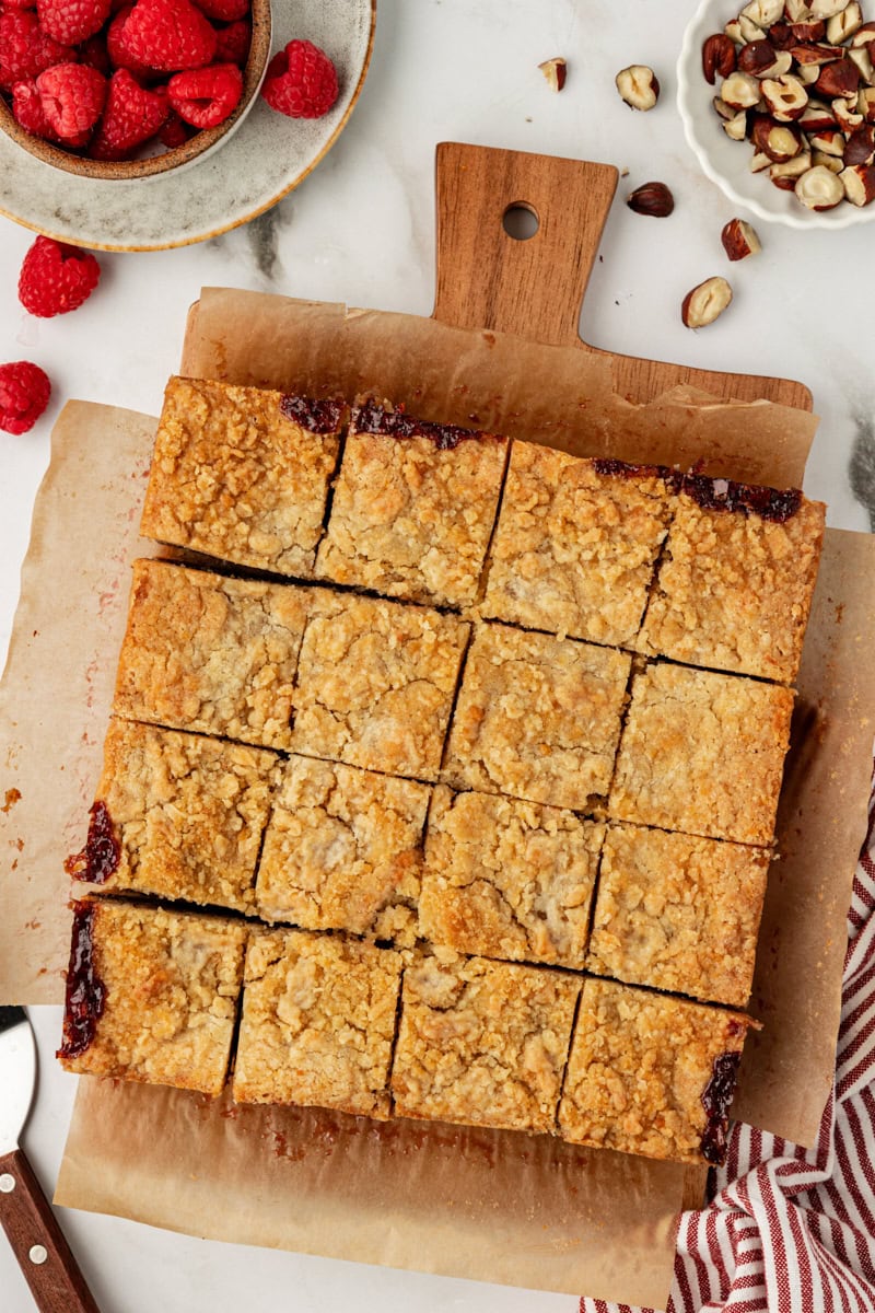 Top-down view of sliced raspberry crumble bars