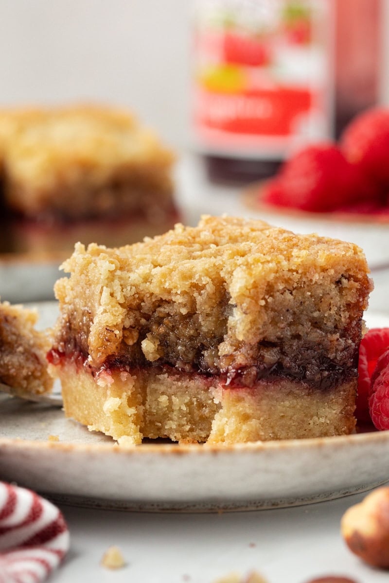 Side view of raspberry crumble bar to show layers