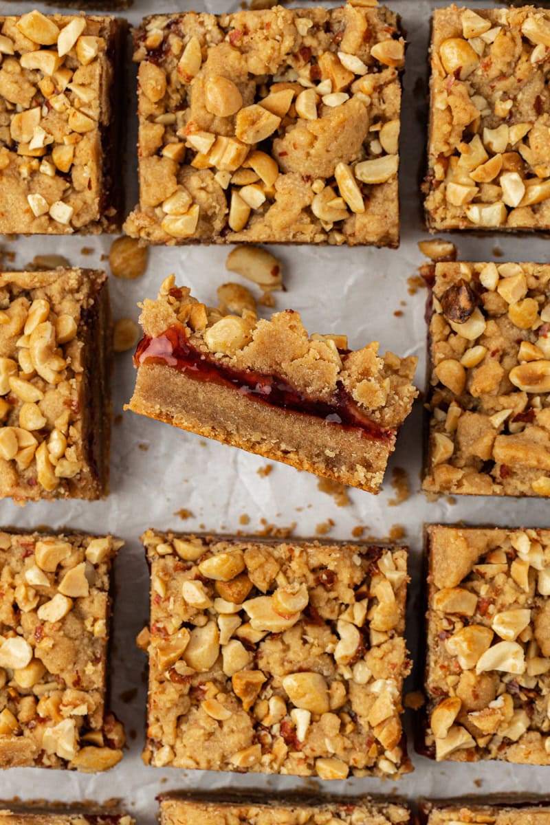 Overhead view of peanut butter and jelly bars with one bar sideways to show layers