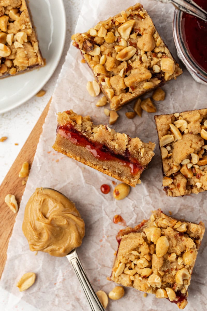 Overhead view of peanut butter and jelly bars on parchment-lined board