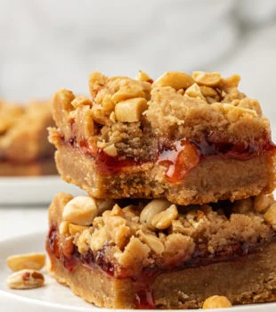 Stack of 2 peanut butter and jelly bars on plate