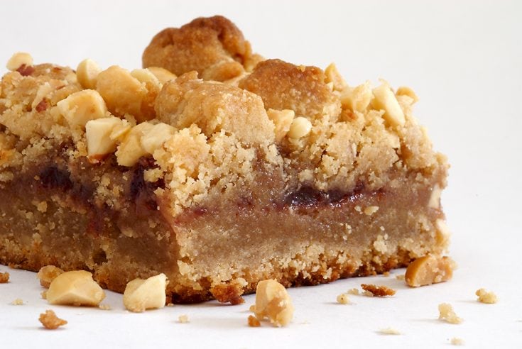 Peanut butter and jelly bars with chopped peanuts.
