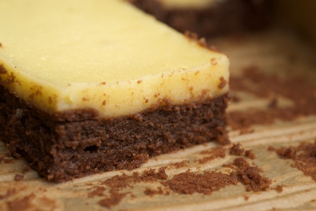 A brownie topped with a cheesecake layer.