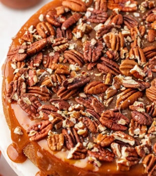 Whole salted caramel cheesecake on cake stand