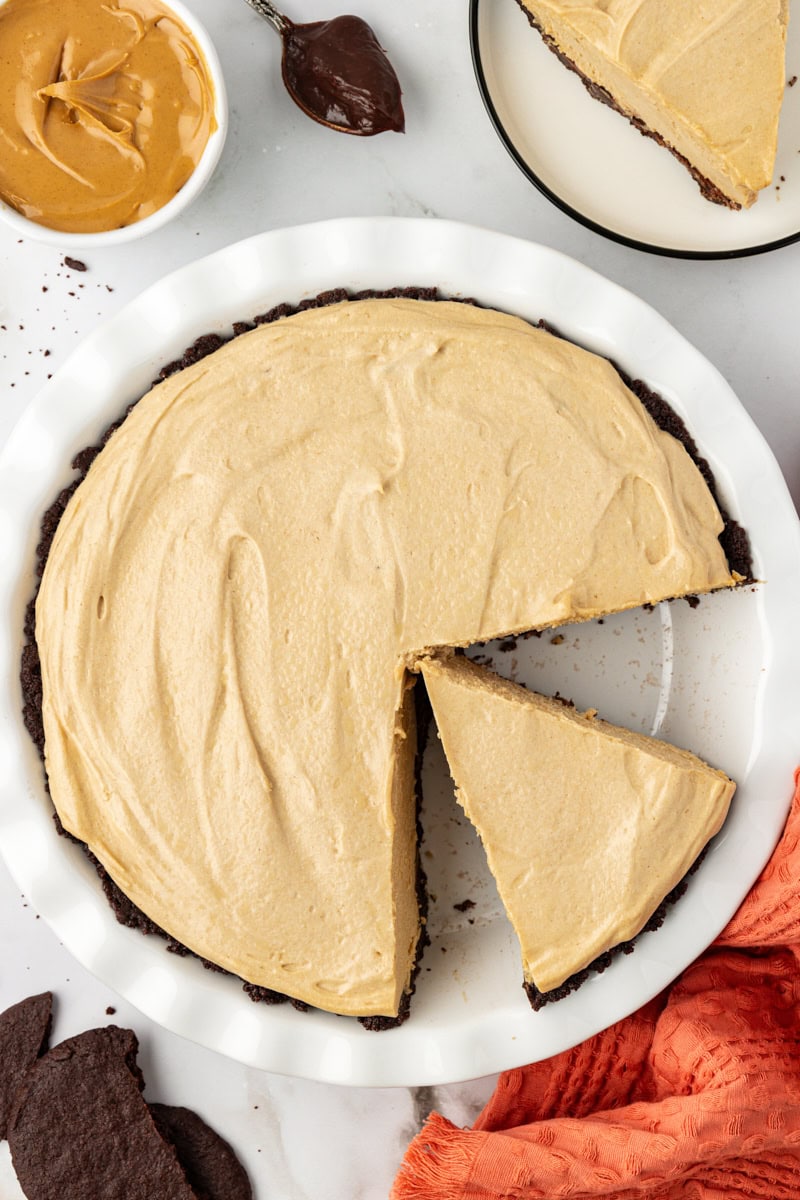 Overhead view of peanut butter pie in pan with 2 slices cut
