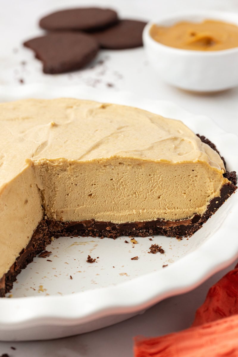 Peanut butter pie in pie dish, sliced to show thick, fluffy filling