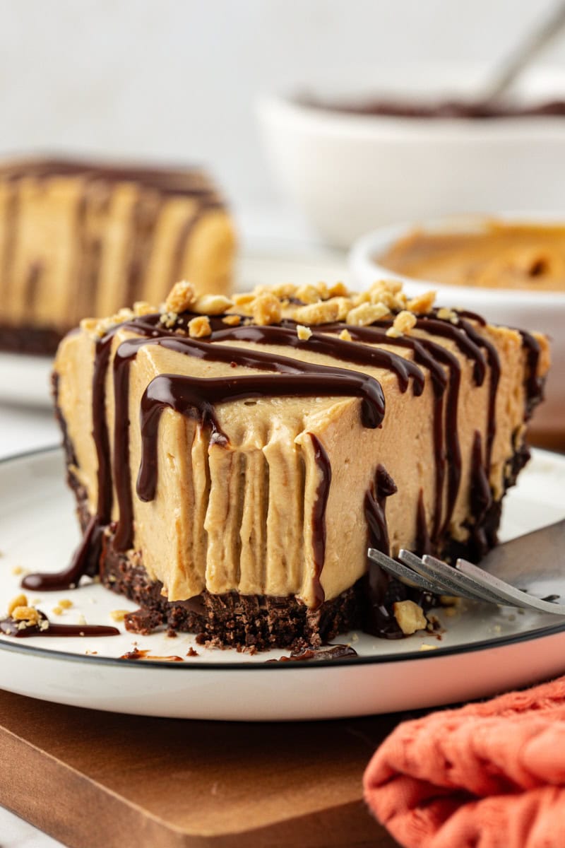 Slice of peanut butter pie on plate with tip eaten